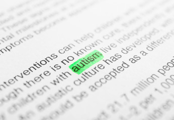 Fototapeta premium Newspaper article and word AUTISM underlined with green marker