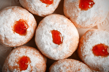 Close up view of plate with tasty donuts. Hanukkah celebration concept