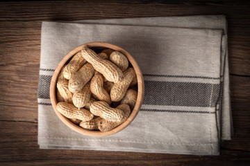 Peanuts in wooden bowl.