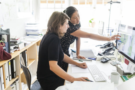 Two landscape architects at work in the office - Powered by Adobe