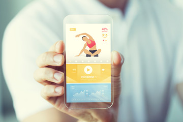close up of hand with sport app on smartphone