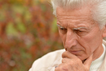 Sad elderly man outdoors