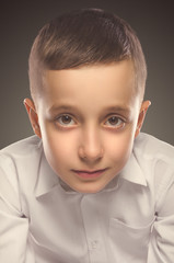 Young boy portrait. Smiling boy looking at camera.