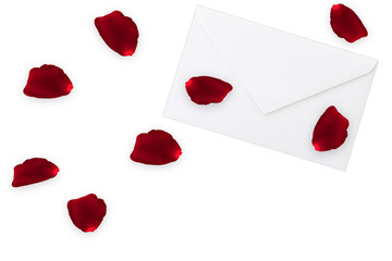 red rose petals on white envelope