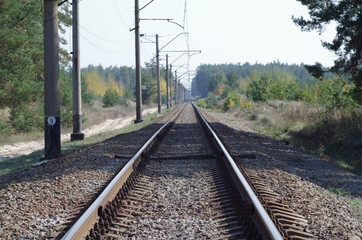 Fototapeta na wymiar Old rails in landscape. Rails in the forest