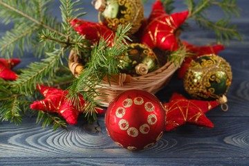 Closeup of Christmas ball with pine branch on wooden background