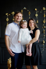 Family with little daughter is photographed in day of a holiday.