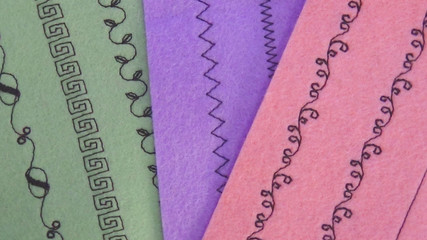 sewing machine stitches on pastel green, purple and pink felt