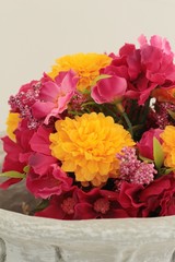 Artificial flowers in a beautiful vase.