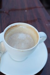 Coffee espresso in cup on wood background.