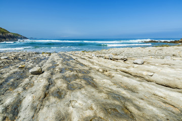 Rocky beach near cliffs in Spain
