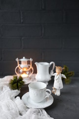 hot tea and christmas candle in dark room/warm winter evening/