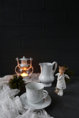 hot tea and christmas candle in dark room/warm winter evening/