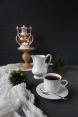 hot tea and christmas candle in dark room/warm winter evening/