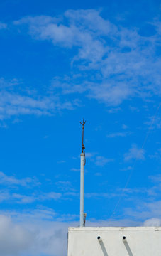lightning rod on roof with blue sky background