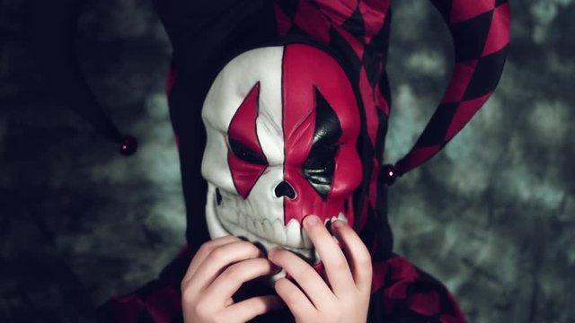 4k Halloween Shot of a Child in Joker Costume Taking it Off