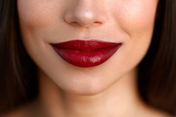 Fototapeta premium Closeup Beautiful Woman Lips With Red Lipstick. Beauty Makeup