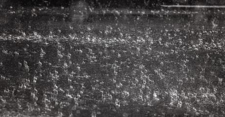 Rain on asphalt or tarmac road creating ripples