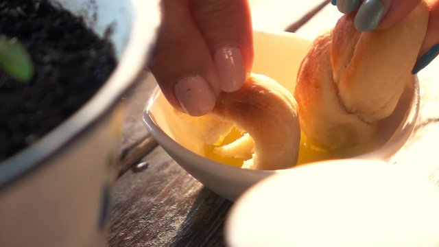 Woman dipping bread in olive oil, super slow motion 240fps
