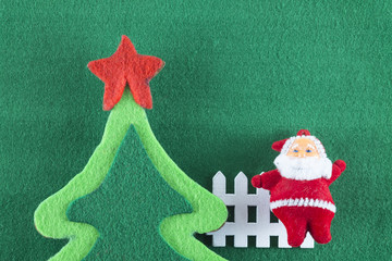 Merry Christmas and Happy New Year,
Santa Claus with Christmas tree on green background