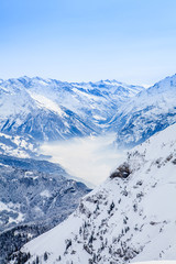 Fototapeta na wymiar Winter snow covered mountain peaks in Europe. The Alps winter mo