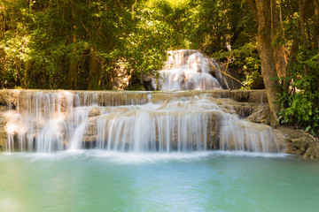 Stream waterfalls in deep tropical jungle, natural landscape background