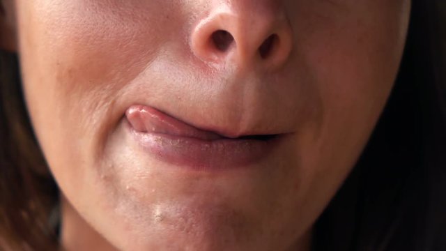 Close up of woman licking her lips, super slow motion 240fps
