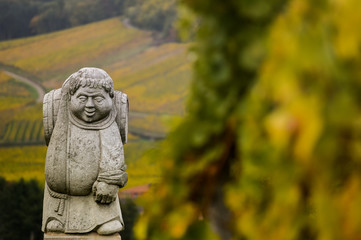 Fototapeta na wymiar Andlau, Alsace village, vineyard, statue of monk carrying wine barrel