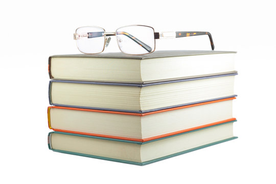 books with glasses on a white background