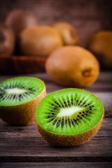 organic fresh juicy kiwi on dark wooden background © nblxer