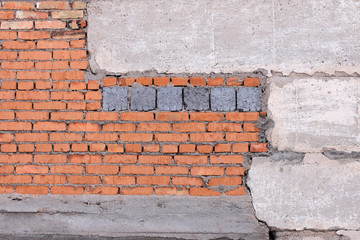 brick wall with cracked plaster and concrete slab