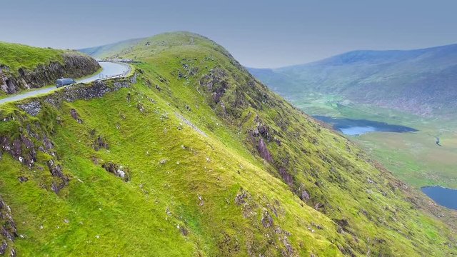 The cliff of the mountain in the Skyroad where cars pass by on the side of the mountain going up in Ireland