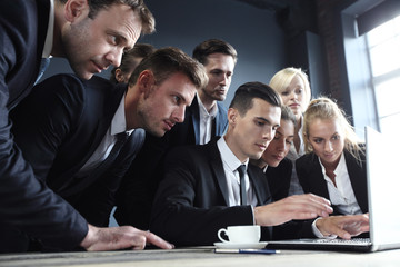 Business people look at laptop