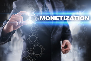 Businessman selecting monetization on virtual screen.