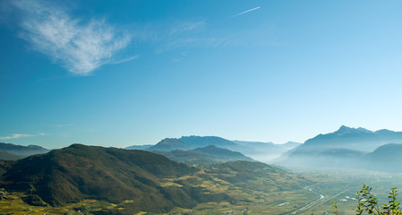 Mountain range in Italy.Trentino,Italy,October 29, 2016, Panorama of the mountains of Trento in autumn,still visible the morning mist.