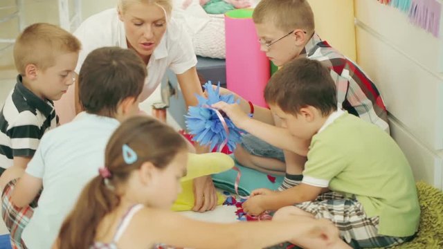 Children Making Paper Flowers at the Kindergarten

