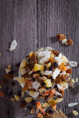 Nuts and dried fruits on wooden background