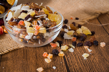 Nuts and dried fruits on wooden background