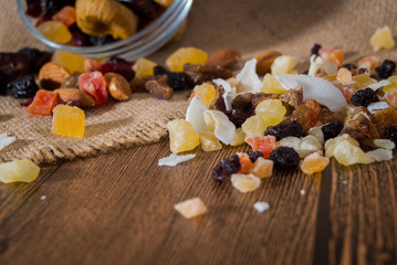 Nuts and dried fruits on wooden background
