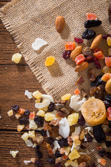 Nuts and dried fruits on wooden background