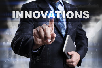 Businessman is pressing button on touch screen interface and selecting innovations.