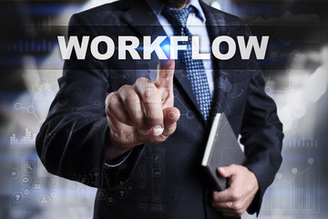 Businessman is pressing button on touch screen interface and selecting workflow.