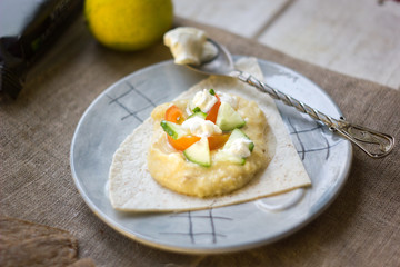 Shot of hummus - vegetarian dish from middle east. Hummus with tomatoes, cucumbers and cheese.