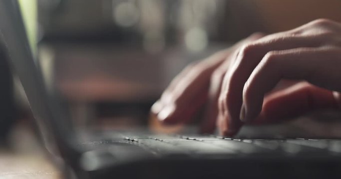 young female hands using notebook on a table in cafe