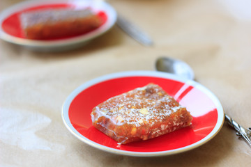 Quince jelly on red ceramic plate.