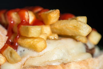 sandwich with meat, cheese and ketchup