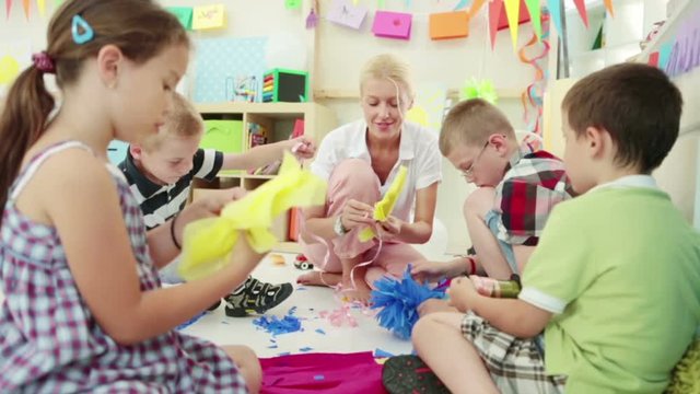 Children Making Paper Flowers at the Kindergarten
