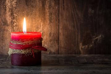 Red Christmas candle on wooden table
