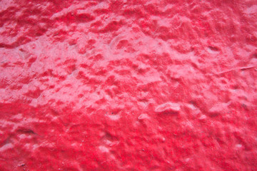 Rough red painted on cement floor texture background