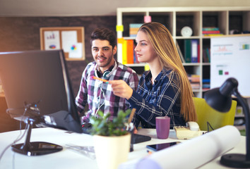 Couple of web designers working together at modern office